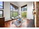 Bright living room with large windows, wood floors, and cozy fireplace at 3900 Bogey Ct, Longmont, CO 80503