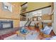 Inviting living room boasts a cozy fireplace and open staircase to upper level at 3900 Bogey Ct, Longmont, CO 80503