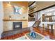 Spacious living room with a brick fireplace, hardwood floors, and an open layout with natural light at 3900 Bogey Ct, Longmont, CO 80503