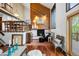 Cozy living room with fireplace, hardwood floors, and a view of the dining area above at 3900 Bogey Ct, Longmont, CO 80503