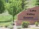 Stone sign for Lake Valley Estates with decorative brick base and landscaping at 3900 Bogey Ct, Longmont, CO 80503