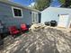Concrete back patio with seating area, BBQ grill, and entrance to the garage at 6179 S Bemis St, Littleton, CO 80120