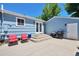 Backyard with a patio area, including a built-in grill and red patio furniture at 6179 S Bemis St, Littleton, CO 80120
