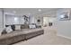 Cozy basement with plush sofa and storage ottoman and views of adjacent room at 6179 S Bemis St, Littleton, CO 80120