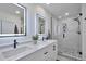 Modern bathroom featuring dual sinks, quartz countertop, and a spacious glass-enclosed shower at 6179 S Bemis St, Littleton, CO 80120
