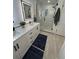 Modern bathroom with double sinks, walk-in shower, and contemporary design at 6179 S Bemis St, Littleton, CO 80120