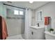 Updated bathroom with a walk-in shower, modern fixtures, and neutral colors for a clean aesthetic at 6179 S Bemis St, Littleton, CO 80120