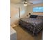 Cozy bedroom with floral bedding, neutral walls, and natural light from window at 6179 S Bemis St, Littleton, CO 80120