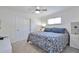 Inviting bedroom featuring a comfortable bed, neutral walls, and a closet for storage at 6179 S Bemis St, Littleton, CO 80120