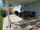 The home has a nice covered deck with comfortable patio furniture at 6179 S Bemis St, Littleton, CO 80120
