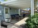 Covered deck with an outdoor sofa and chairs, providing an ideal place to relax at 6179 S Bemis St, Littleton, CO 80120