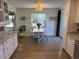 Bright dining area featuring white walls, wood floors, white table and chairs, and natural light at 6179 S Bemis St, Littleton, CO 80120