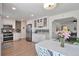 Well-appointed kitchen with stainless steel appliances, white cabinetry and an adjacent dining area at 6179 S Bemis St, Littleton, CO 80120