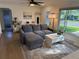 Inviting living room with comfortable gray seating, hardwood floors, and ample natural light at 6179 S Bemis St, Littleton, CO 80120