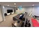 Finished basement with a large comfy sectional couch, tv, and workout equipment at 6179 S Bemis St, Littleton, CO 80120