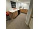 Finished basement with a wet bar featuring wooden cabinets, a sink and mini fridge at 6179 S Bemis St, Littleton, CO 80120