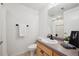 Small bathroom with shower, toilet, and a wood vanity at 3195 Blake St # 201, Denver, CO 80205