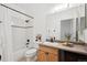 Clean bathroom with tub, shower, and wood vanity at 3195 Blake St # 201, Denver, CO 80205