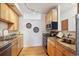 Kitchen with light wood cabinets, granite counters, and stainless steel appliances at 3195 Blake St # 201, Denver, CO 80205