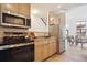 Bright kitchen featuring stainless steel appliances and ample cabinet space at 3195 Blake St # 201, Denver, CO 80205