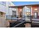 Elevated condo patios with stairs leading up, patio furniture, and views at 3195 Blake St # 201, Denver, CO 80205