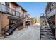 Outdoor patio area between condominium buildings with stairwells and concrete pavers at 3195 Blake St # 201, Denver, CO 80205