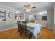 Cozy dining area featuring hardwood floors, a ceiling fan, and an open view into the living room and kitchen at 1263 W 103Rd Pl, Northglenn, CO 80260
