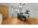 Charming dining room boasts hardwood floors, a ceiling fan, and a large window, perfect for Gathering meals at 1263 W 103Rd Pl, Northglenn, CO 80260