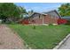 Lovely brick home with gray siding and a cozy red porch, set on a well-maintained lawn and landscape at 1263 W 103Rd Pl, Northglenn, CO 80260