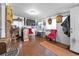 A room showcasing a bar area with seating and decorated walls and wood-like flooring at 1263 W 103Rd Pl, Northglenn, CO 80260