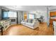 Bright living room with hardwood floors and large windows offers a welcoming atmosphere and easy access to other rooms at 1263 W 103Rd Pl, Northglenn, CO 80260