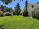 Expansive backyard with lush green lawn, mature trees, and well-maintained landscaping at 8535 E Otero Cir, Centennial, CO 80112