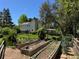 Spacious backyard with garden, lush lawn, mature trees, and a covered patio, perfect for outdoor relaxation at 8535 E Otero Cir, Centennial, CO 80112