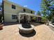 Spacious backyard with a large patio, fire pit, and mature trees, perfect for relaxing and entertaining guests at 8535 E Otero Cir, Centennial, CO 80112