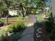 Picturesque backyard with a rustic fence, a lush garden, and a stone pathway at 8535 E Otero Cir, Centennial, CO 80112