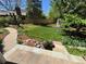 Backyard oasis featuring a well-manicured lawn, stone pavers, and colorful flowerbeds at 8535 E Otero Cir, Centennial, CO 80112