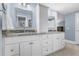 Well-lit bathroom featuring double sinks with granite countertops, and shaker style cabinets at 8535 E Otero Cir, Centennial, CO 80112