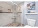 Modern bathroom featuring a glass enclosed shower with tiled walls and a decorative tiled floor at 8535 E Otero Cir, Centennial, CO 80112