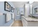 Bathroom featuring a vanity with granite countertops, decorative backsplash, and storage cabinet at 8535 E Otero Cir, Centennial, CO 80112