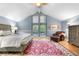Spacious bedroom with vaulted ceilings, a large window, and a sitting area by the upholstered chair at 8535 E Otero Cir, Centennial, CO 80112