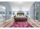 Charming bedroom featuring a wooden bed frame, wall trim, and natural light from the side window at 8535 E Otero Cir, Centennial, CO 80112