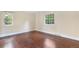 Bedroom with hardwood floors, natural light, neutral colors, and backyard views at 8535 E Otero Cir, Centennial, CO 80112