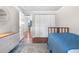 Cozy bedroom with a blue bedspread, dresser, and closet with an open door to an adjoining room at 8535 E Otero Cir, Centennial, CO 80112
