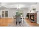 Dining room with fireplace, hardwood floors, neutral colors, and backyard access at 8535 E Otero Cir, Centennial, CO 80112