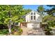 Inviting two-story home with manicured landscaping, a brick facade, and an attached two-car garage at 8535 E Otero Cir, Centennial, CO 80112