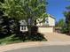 Lovely home with a well-manicured lawn, mature trees, and a welcoming front entrance at 8535 E Otero Cir, Centennial, CO 80112