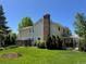 Home exterior featuring a well-maintained lawn, established trees, covered patio, and brick chimney at 8535 E Otero Cir, Centennial, CO 80112