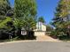 Charming home with mature trees, well-kept landscaping, and a brick driveway at 8535 E Otero Cir, Centennial, CO 80112