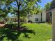 Exterior featuring an expansive lawn, lush landscaping, and covered patio perfect for entertaining at 8535 E Otero Cir, Centennial, CO 80112