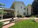 Back exterior featuring well kept lawn, landscaped garden, and covered patio for relaxing and entertaining at 8535 E Otero Cir, Centennial, CO 80112